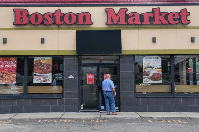 FILE - A man reads a stop work order posted on the door of a Boston Market restaurant in Hackensack, N.J., Thursday, Aug. 17, 2023. State labor officials have lifted a stop-work order, Friday, Sept. 15, 2023, that had temporarily shut down more than two dozen Boston Market restaurants in New Jersey. The move came after officials say the owner paid more than $630,000 in back wages to hundreds of workers. (AP Photo/Seth Wenig, File)