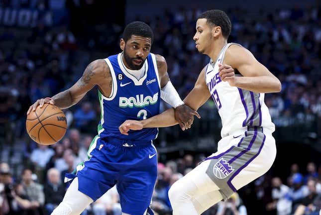 Apr 5, 2023; Dallas, Texas, USA;  Dallas Mavericks guard Kyrie Irving (2) drives to the basket as Sacramento Kings forward Keegan Murray (13) defends during the first half at American Airlines Center.