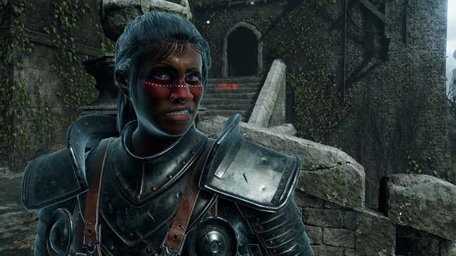 An Elden Ring character with dark skin and red cheeks snarls at the camera while standing outside a stone tower.