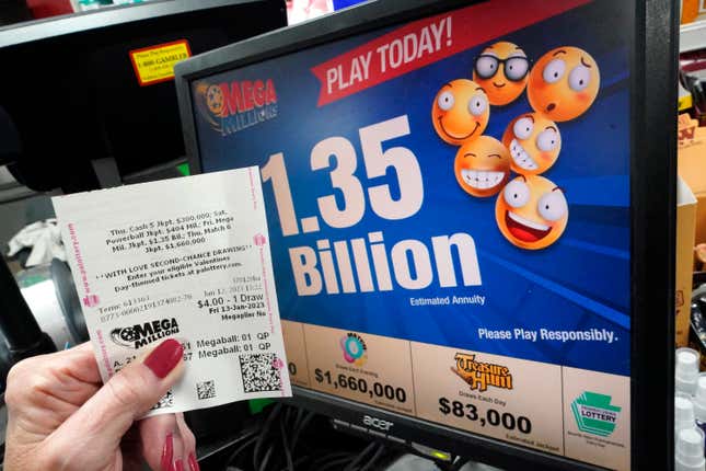 A hand holds Mega Millions lottery tickets for the Friday, January 13 drawing.