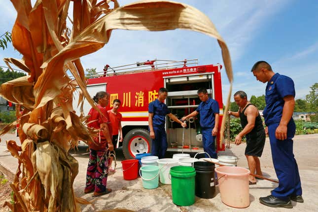 Villagers get water from a fire truck in Suining in Sichuan province on August 23.