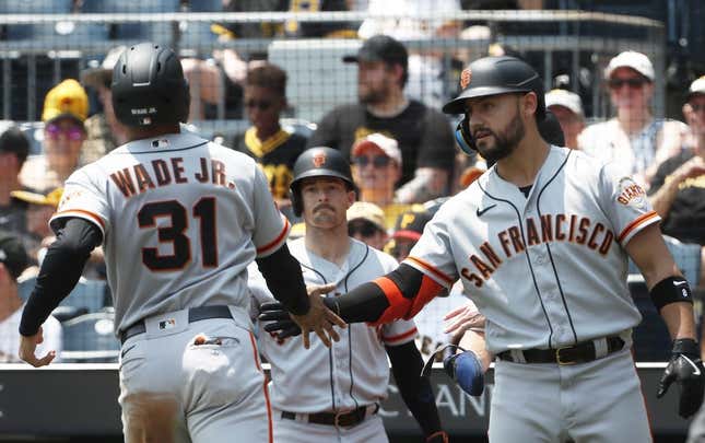 Jul 16, 2023; Pittsburgh, Pennsylvania, USA; San Francisco Giants right fielder Michael Conforto (8) greets first baseman LaMonte Wade Jr. (31) crossing home plate to score a run against the Pittsburgh Pirates during the third inning at PNC Park.