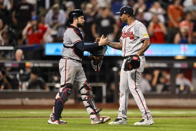Aug 12, 2023; New York City, New York, USA; Atlanta Braves catcher Travis d&#39;Arnaud (16) and Atlanta Braves relief pitcher Raisel Iglesias (26) shake hands after winning 6-0 against the New York Mets at Citi Field.