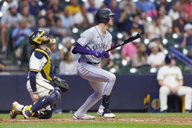Aug 8, 2023; Milwaukee, Wisconsin, USA;  Colorado Rockies left fielder Nolan Jones (22) hits a sacrifice fly ball during the tenth inning against the Milwaukee Brewers at American Family Field.
