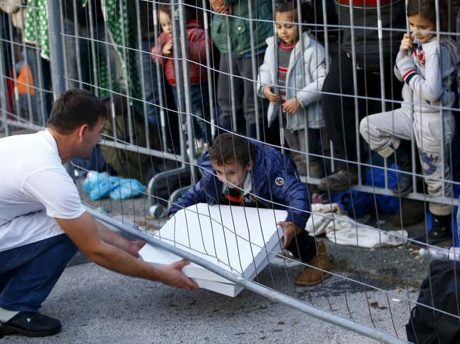 Image for article titled Photos: Hero Slovenian waiter delivers pizza to hungry migrant kids