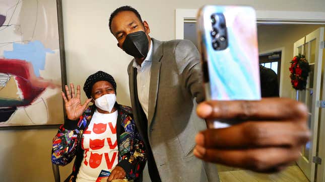 Atlanta mayoral candidate and councilman Andre Dickens pauses for a selfie with Yolanda Napier while visiting with her and other residents during a campaign stop at The Remington, a senior living facility, on the eve of the mayoral runoff election on Monday, Nov. 29, 2021, in Atlanta. 