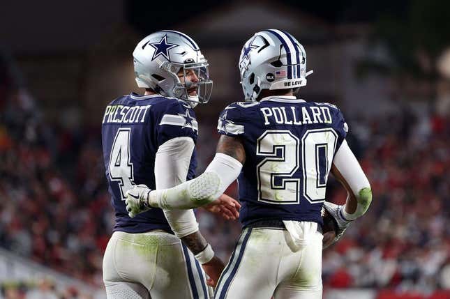 Jan 16, 2023; Tampa, Florida, USA; Dallas Cowboys running back Tony Pollard (20) reacts with quarterback Dak Prescott (4) after a touchdown against the Tampa Bay Buccaneers in the first half during the wild card game at Raymond James Stadium.