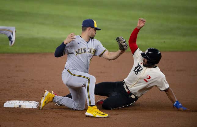 Aug 18, 2023; Arlington, Texas, USA; Texas Rangers second baseman Marcus Semien (2) slides under the tag  of Milwaukee Brewers shortstop Willy Adames (27) as he steals second base during the first inning at Globe Life Field.