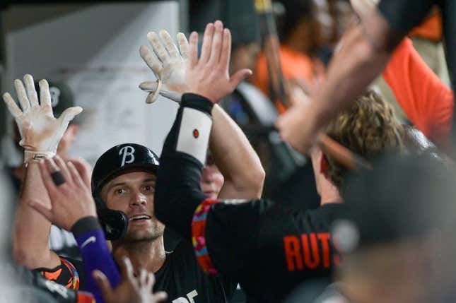 Jul 14, 2023; Baltimore, Maryland, USA;  Baltimore Orioles second baseman Adam Frazier (12) high fives teammates after hitting a fourth  inning solo home run against the Miami Marlins at Oriole Park at Camden Yards.