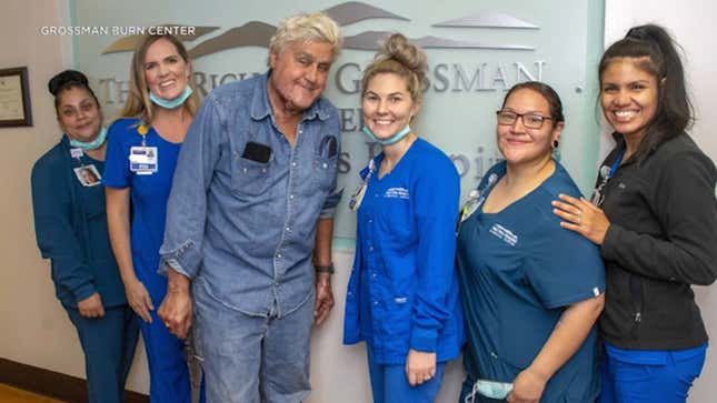 Comedian Jay Leno poses with hospital staff as he is released after burn care.