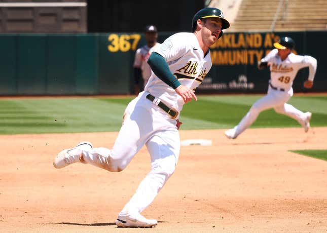 May 31, 2023; Oakland, California, USA; Oakland Athletics left fielder Brett Rooker (25) rounds third base ahead of first baseman Ryan Noda (49) to score a run against the Atlanta Braves during the sixth inning at Oakland-Alameda County Coliseum.