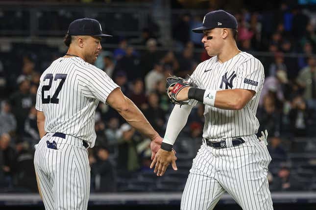 New York Yankees' Giancarlo Stanton (27) celebrates with Aaron