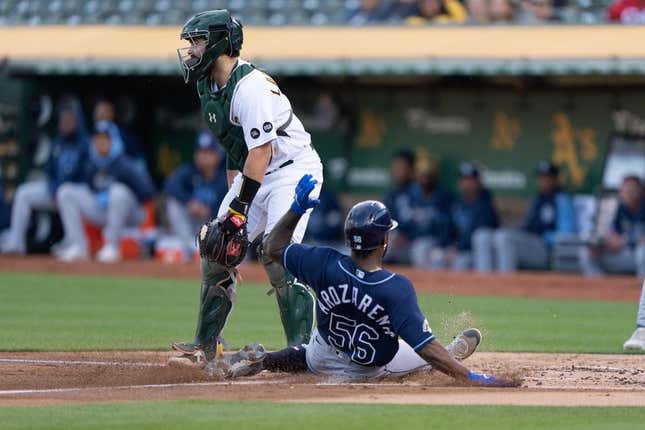 Jun 14, 2023; Oakland, California, USA;  Tampa Bay Rays left fielder Randy Arozarena (56) slides home safe during the second inning against Oakland Athletics catcher Shea Langeliers (23) at Oakland-Alameda County Coliseum.