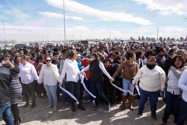 Image for article titled To protest Trump, Mexicans locked arms to form a friendly human wall along the US border