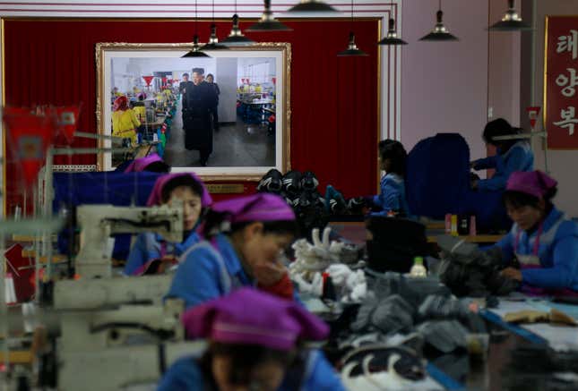 A photograph of North Korean leader Kim Jong Un taken during his visit at Ryuwon Shoe Factory is displayed on the wall of a room at the sports footwear manufacturing facility in Pyongyang, North Korea, Friday, Feb. 1, 2019. (AP Photo/Dita Alangkara)