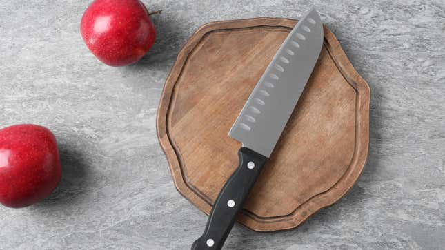 A santoku knife on a cutting board.