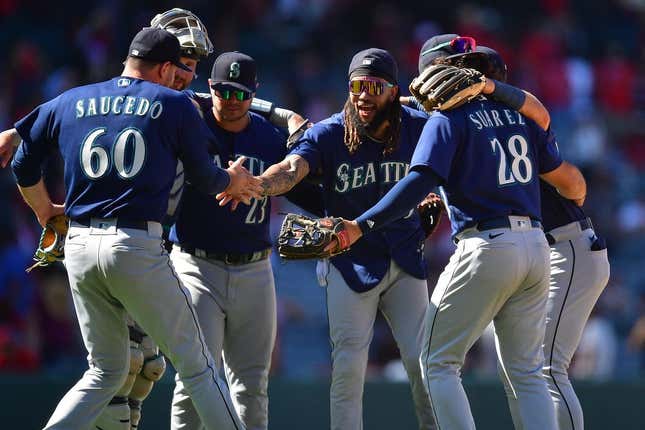 Aug 6, 2023; Anaheim, California, USA; Seattle Mariners relief pitcher Tayler Saucedo (60) first baseman Ty France (23) shortstop J.P. Crawford (3) and third baseman Eugenio Suarez (28) celebrate the victory against the Los Angeles Angels at Angel Stadium.