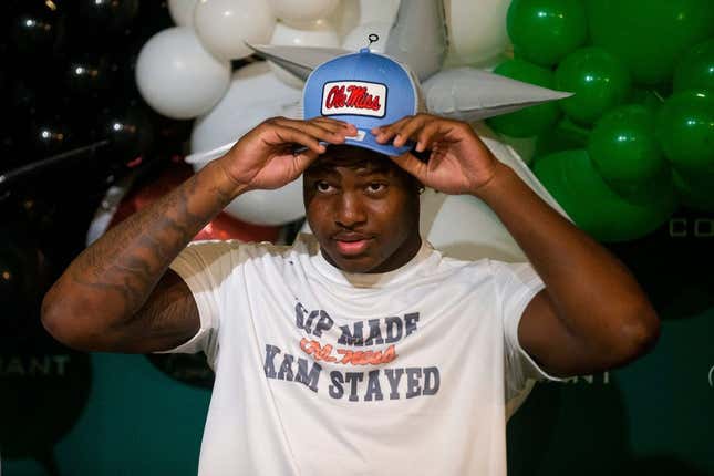 Kamarion Franklin, the No. 1 recruit in Mississippi, puts on an Ole Miss hat as he announces his commitment to Ole Miss football while wearing a shirt that says       Sip Made Kam Stayed    with the Ole Miss logo at Lake Cormorant High School in Lake Cormorant, Miss, on Saturday, August 19, 2023.