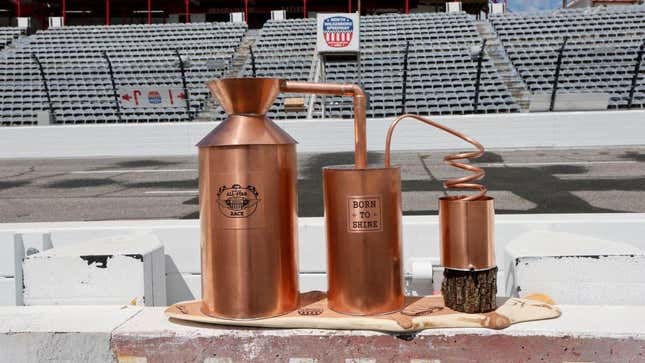 A copper moonshine still trophy that reads "Born to Shine" and bears an emblem of NASCAR's All-Star race logo.