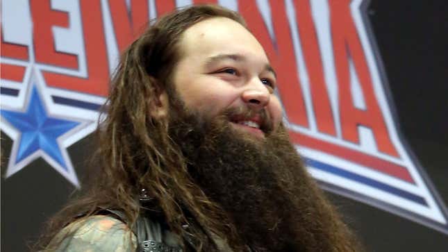 A photo shows Bray Wyatt smiling while attending WWE WrestleMania Stars Ring The NYSE Opening Bell at New York Stock Exchange in 2016. 