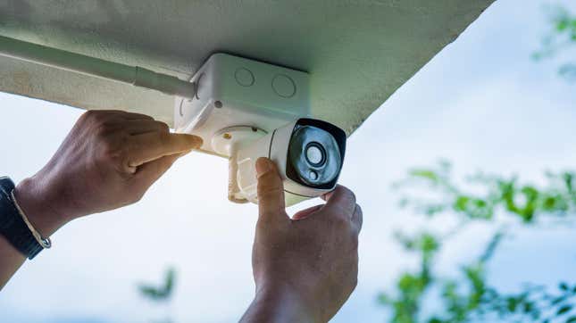 Person installing wireless CCTV camera