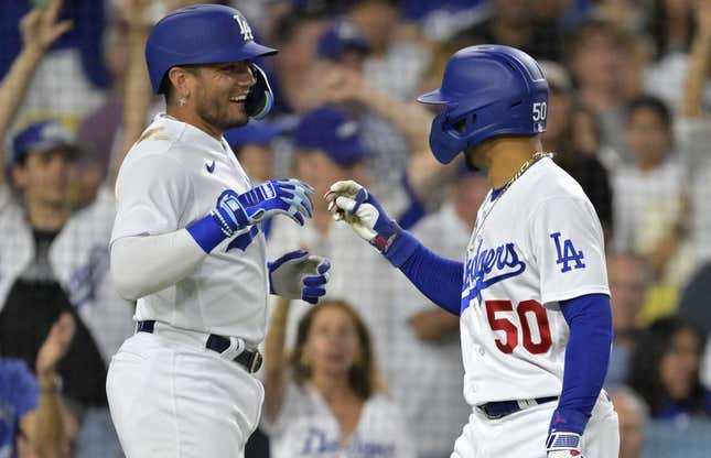 Aug 2, 2023; Los Angeles, California, USA;  Los Angeles Dodgers shortstop Miguel Rojas (11)  is greeted by right fielder Mookie Betts (50) after hitting a solo home run in the third inning against the Oakland Athletics at Dodger Stadium.