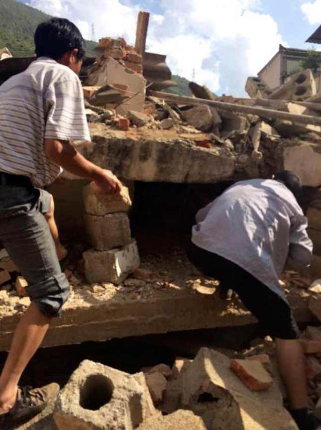 Residents of Ludian county look for survivors.