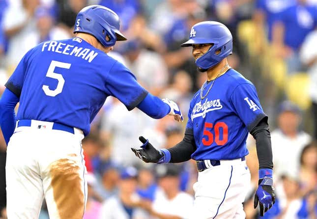Aug 19, 2023; Los Angeles, California, USA; Los Angeles Dodgers right fielder Mookie Betts (50) is congratulated by first baseman Freddie Freeman (5) after hitting a solo home run in the third inning against the Miami Marlins at Dodger Stadium.