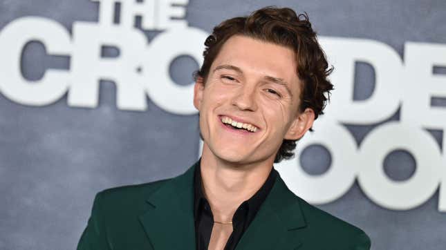 Tom Holland grins on the red carpet for Apple TV show The Crowded Room.