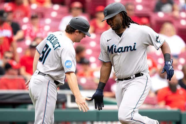 Miami Marlins first baseman Josh Bell (9) greets Miami Marlins quality assurance coach Griffin Benedict (81) after hitting a solo home run in the fourth inning of the MLB baseball game between Cincinnati Reds and Miami Marlins at Great American Ball Park in Cincinnati on Wednesday, Aug. 9, 2023.