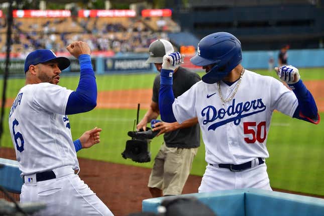 May 31, 2023; Los Angeles, California, USA; Los Angeles Dodgers right fielder Mookie Betts (50) celebrates his solo home run against the Washington Nationals with left fielder David Peralta (6) during the eighth inning at Dodger Stadium.