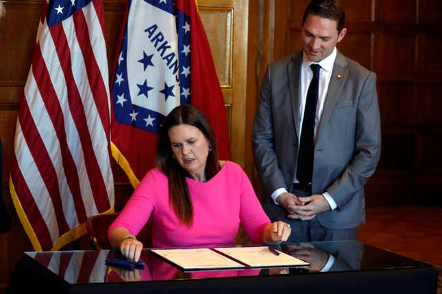 FILE - Arkansas Gov. Sarah Huckabee Sanders signs a bill requiring age verification before creating a new social media account as Sen. Tyler Dees, R-Siloam Springs, looks on during a signing ceremony, Wednesday, April 12, 2023, at the state Capitol in Little Rock, Ark. A federal judge on Thursday, Aug. 31, 2023, temporarily blocked Arkansas from enforcing the new law that would have required parental consent for minors to create new social media accounts, preventing the state from becoming the first to impose such a restriction.(Thomas Metthe/Arkansas Democrat-Gazette via AP, File)