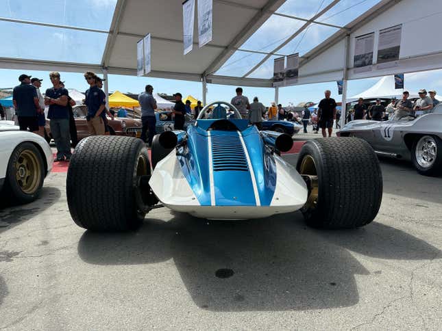 An open wheel classic Corvette prototype race car is parked at Laguna Seca