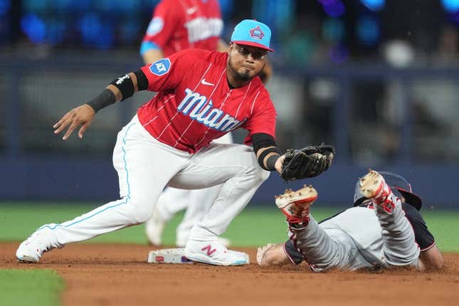 Aug 26, 2023; Miami, Florida, USA; Miami Marlins second baseman Luis Arraez (3) tags out Washington Nationals third baseman Jake Alu (39) trying to steal second base in the fifth inning at loanDepot Park.