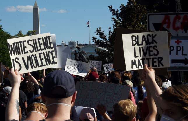 Demonstrators protesting the death of George Floyd hold up placards near the White House on June 1, 2020 in Washington, DC.