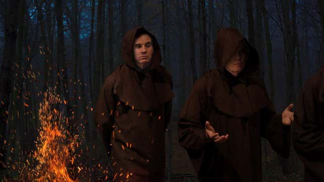 Image for article titled Robed Mark Warner Infiltrates Secret Torchlit AHCA Ceremony Deep In Woods Behind Capitol