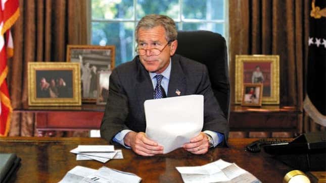 Bush examines his credit-card statements.