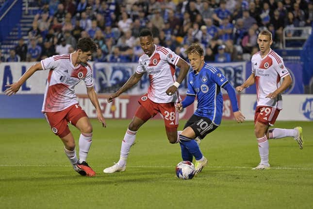 Aug 26, 2023; Montreal, Quebec, CAN; CF Montreal midfielder Bryce Duke (10) dribbles the ball around New England Revolution midfielder Mark-Anthony Kaye (28) and midfielder Ian Harkes (14) during the first half at Stade Saputo.