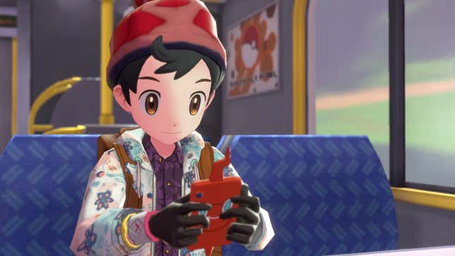 A trainer is seen holding his phone on a train.