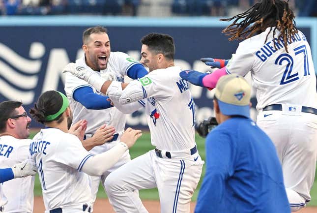 Sep 16, 2023; Toronto, Ontario, CAN; Toronto Blue Jays left fielder Whit Merrifield (15) celebrates with teammates after driving in the winning run against the Boston Red Sox in the 13th inning at Rogers Centre.