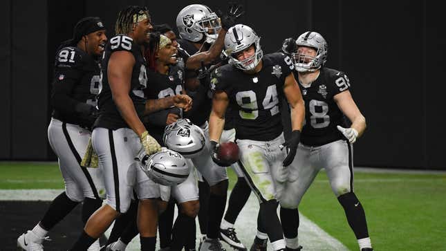 Defensive end Carl Nassib, who recently came out, celebrates with Raiders teammates after he intercepted a Denver Broncos’ pass in the second half of their game at Allegiant Stadium on November 15, 2020, in Las Vegas.