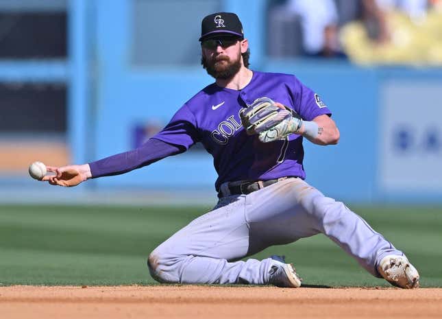 Oct 2, 2022; Los Angeles, California, USA; Colorado Rockies second baseman Brendan Rodgers (7) makes a play to throw out Los Angeles Dodgers first baseman Freddie Freeman (5) at second base in the sixth inning at Dodger Stadium.