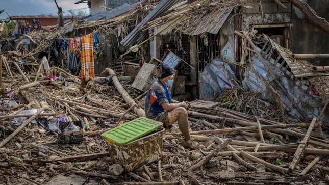 A resident sits outside destroyed houses after Typhoon Vamco hit on Nov. 14, 2020 in Rodriguez, Philippines.
