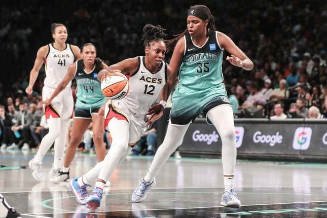 Aug 6, 2023; Brooklyn, New York, USA;  Las Vegas Aces guard Chelsea Gray (12) looks to drive past New York Liberty forward Jonquel Jones (35) in the third quarter at Barclays Center.