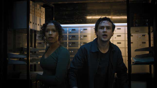 Zoey Davis (Taylor Russell) and Ben Miller (Logan Miller) look shocked while standing in a safety deposit box room in Escape Room: Tournament of Champions.