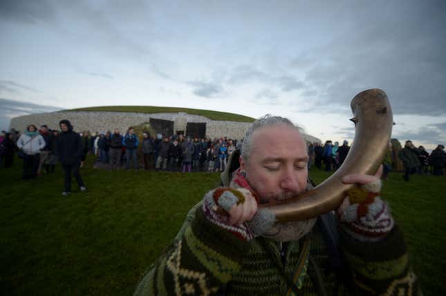 A reveller celebrates winter solstice at the Newgrange on Dec 21, 2016.
