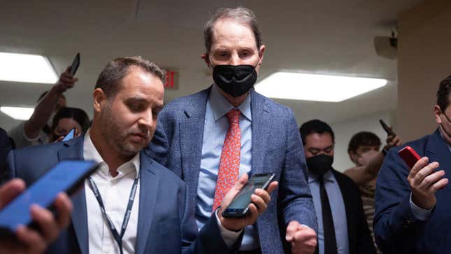 Sen. Ron Wyden (D-Ore.) speaks with reporters as he walks to a vote at the U.S. Capitol July 18, 2022.