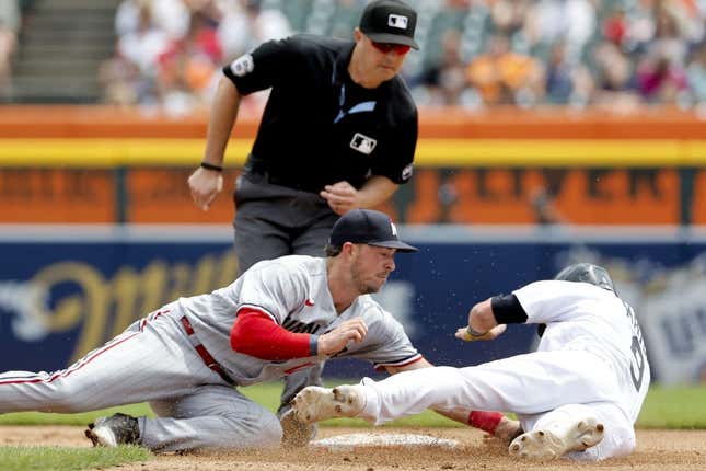 Jun 25, 2023; Detroit, Michigan, USA; Detroit Tigers third baseman Nick Maton (9) is tagged out by Minnesota Twins third baseman Kyle Farmer (12) trying to steal second in the fourth inning at Comerica Park.