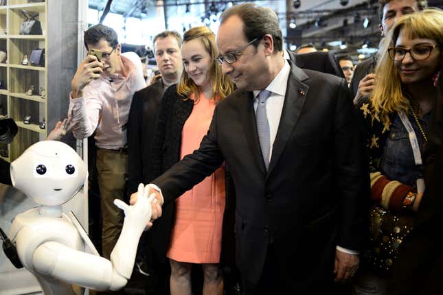 French President Francois Hollande shakes hands with Pepper during his visit to the Viva technology event in Paris on June 30, 2016.
