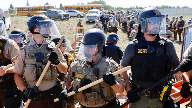 Police in riot gear face off environmental activists at the Line 3 pipeline pumping station near the Itasca State Park, Minnesota on June 7, 2021.